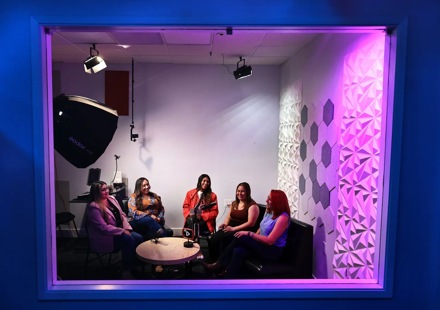 Members recording a podcast together